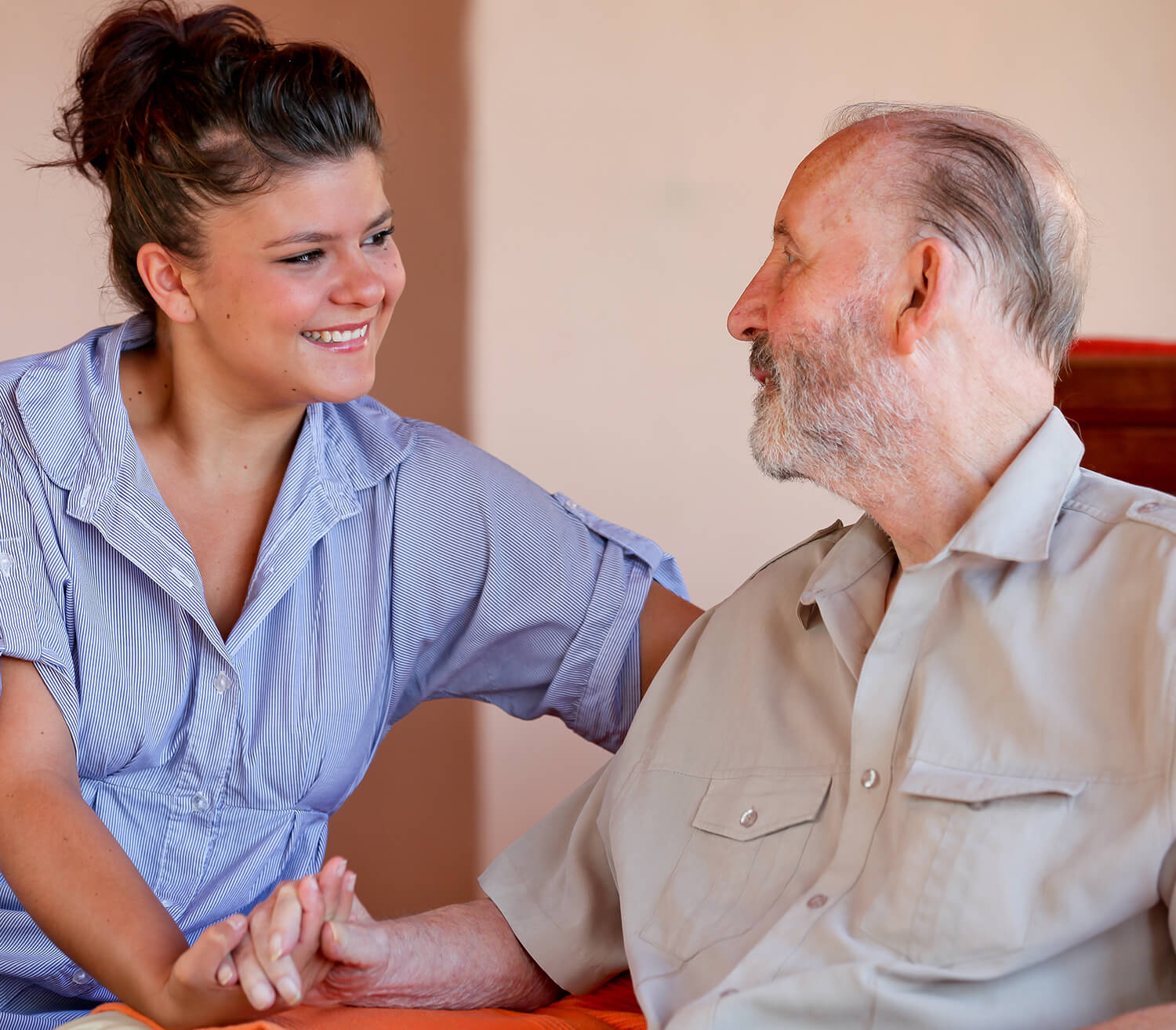 Young woman comforting an elderly man