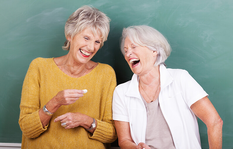 Two mature woman laughing together