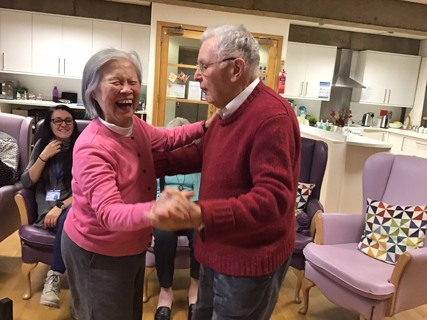 Elderly couple dancing and smiling